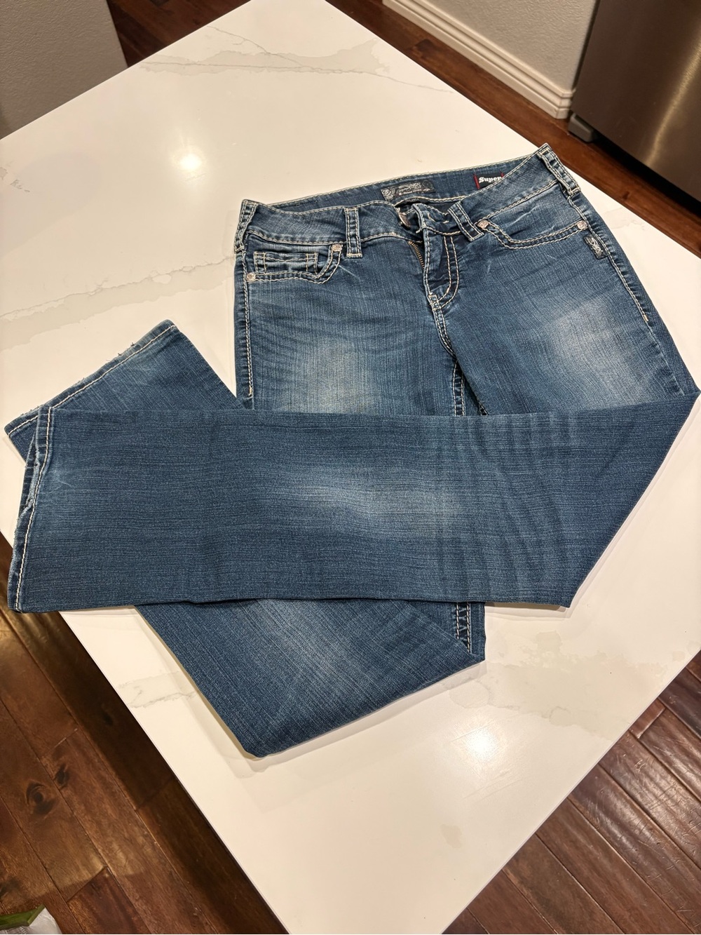 Silver Jeans SUKI Women's Boot Cut Denim in Blue Wash. Lightly Distressed.